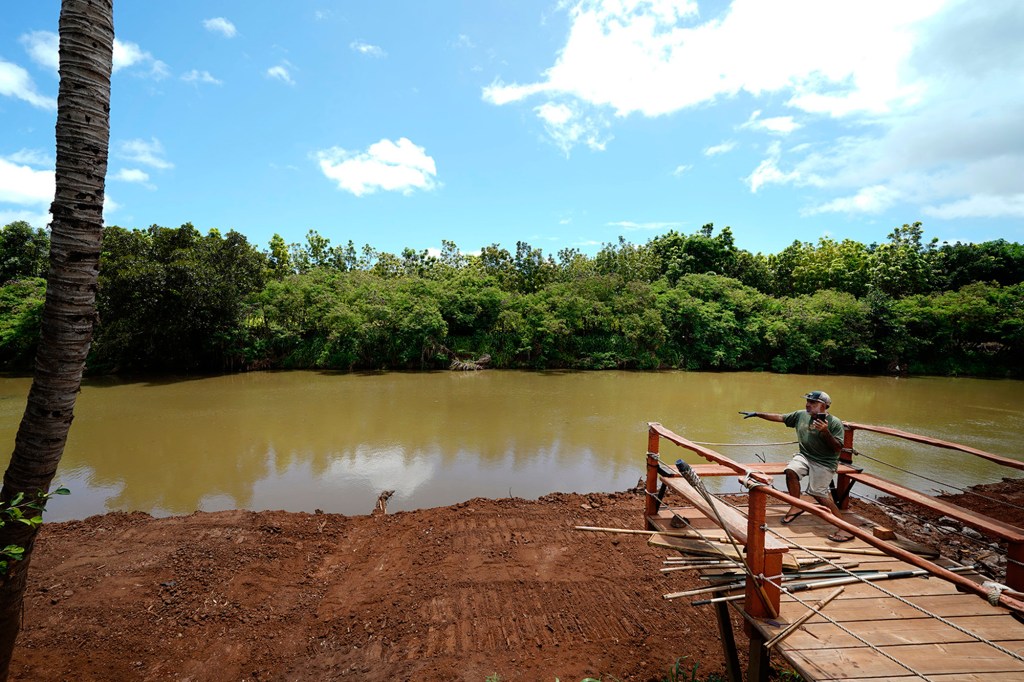 Rafe Maldonado shows a Civil Beat reporter on a FaceTime video call the the Kaukonahua Stream behind his Waialua home Thursday, June 11, 2026. The stream has been cleared of an island since the Kona Low storms flooded his and neighbors’ homes. (Kevin Fujii/Civil Beat/2026)