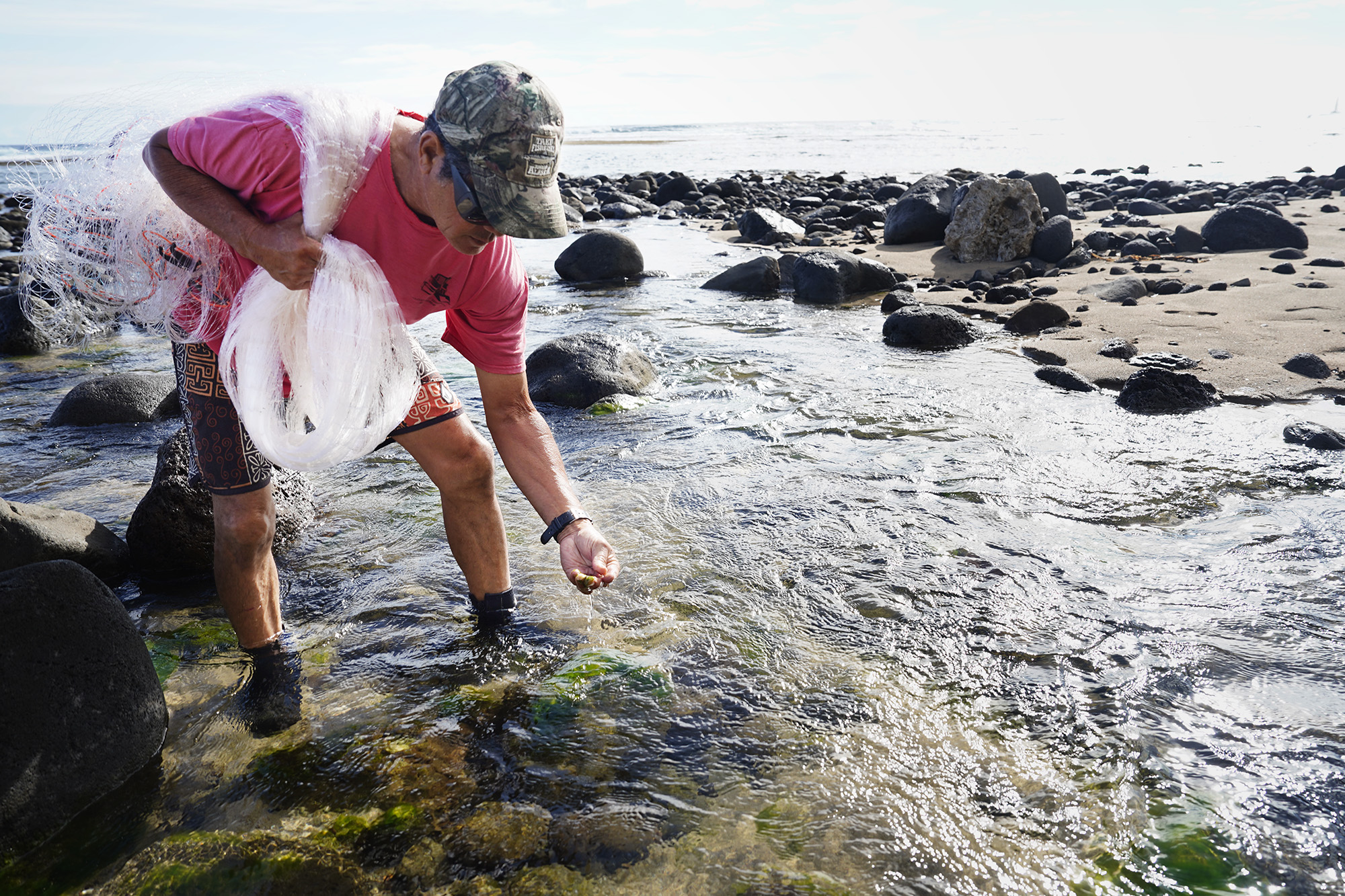 Keli‘i Alapa‘i checks the algae growing in a freshwater stream in the Hāʻena community fishing area Sunday, June 28, 2026, in Hāʻena. Various types of vegetation will attract certain fish.
