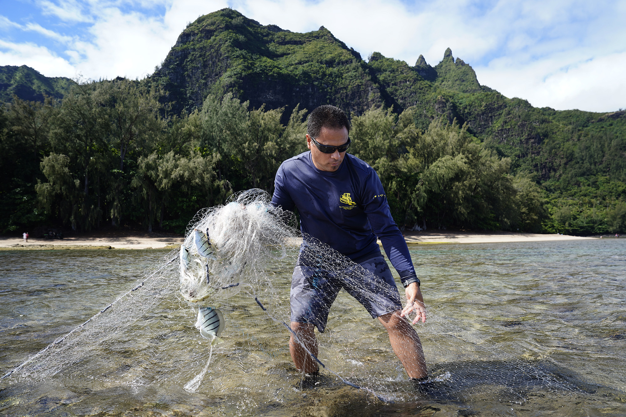 Kanoe Alapa‘i-Hashimoto pulls in his catch of manini in Hāʻena community fishing waters Sunday, June 28, 2026, in Hāʻena.