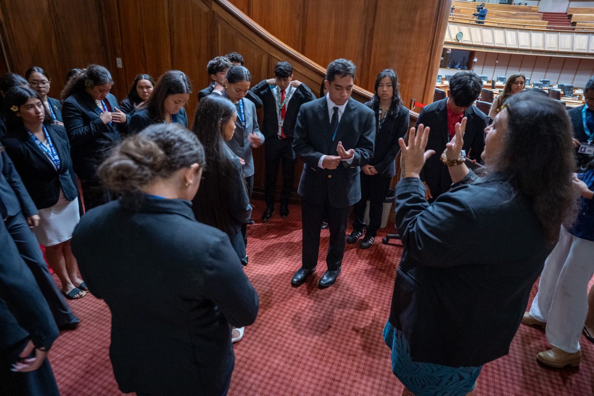 Brittney Kamele Kapaona, right, gives instruction on next steps to high school delegates to 'Aha 'Ōpio at the Capitol June 22, 2026. After a 25 year hiatus, the Office of Hawaiʻian Affairs brought together students from around Hawaiʻi and the continent to learn and participate in hands-on civics. Kamele Kapaona was 11 and sitting at the knee of founder Rona Rodenhurst at the first 'Aha 'Opio in 1988. (Craig Fujii/Civil Beat/2026)