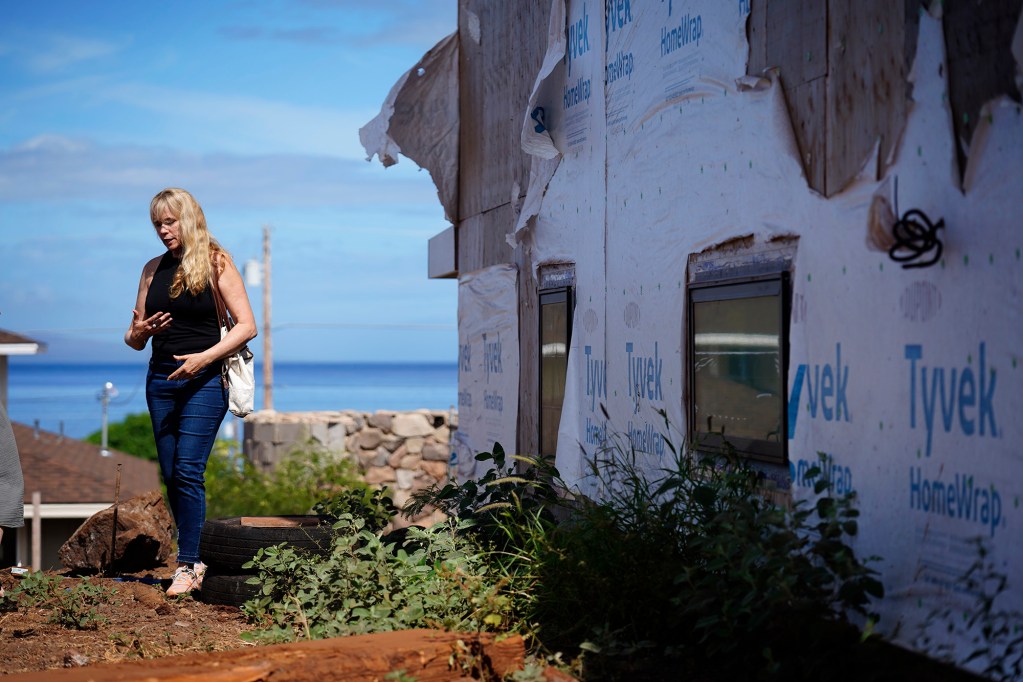 Krista Woodward points out below-standard workmanship at her stalled home reconstruction Wednesday, July 1, 2026, in Lahaina. Woodward’s contractor allegedly scammed her and others rebuilding in Lahaina. (Kevin Fujii/Civil Beat/2026)