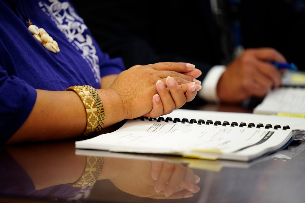 The hands of Kula Aupuni Niihau A Kahelelani Aloha’s Kaleolani Stevens and Attorney General office lawyer Carter Siu appear in court Wednesday, July 22, 2026, in Līhuʻe. One of the few schools dedicated to teaching the Niʻihau dialect of the Hawaiian language is at risk of losing its campus with the school year just a few weeks away. (Kevin Fujii/Civil Beat/2026)