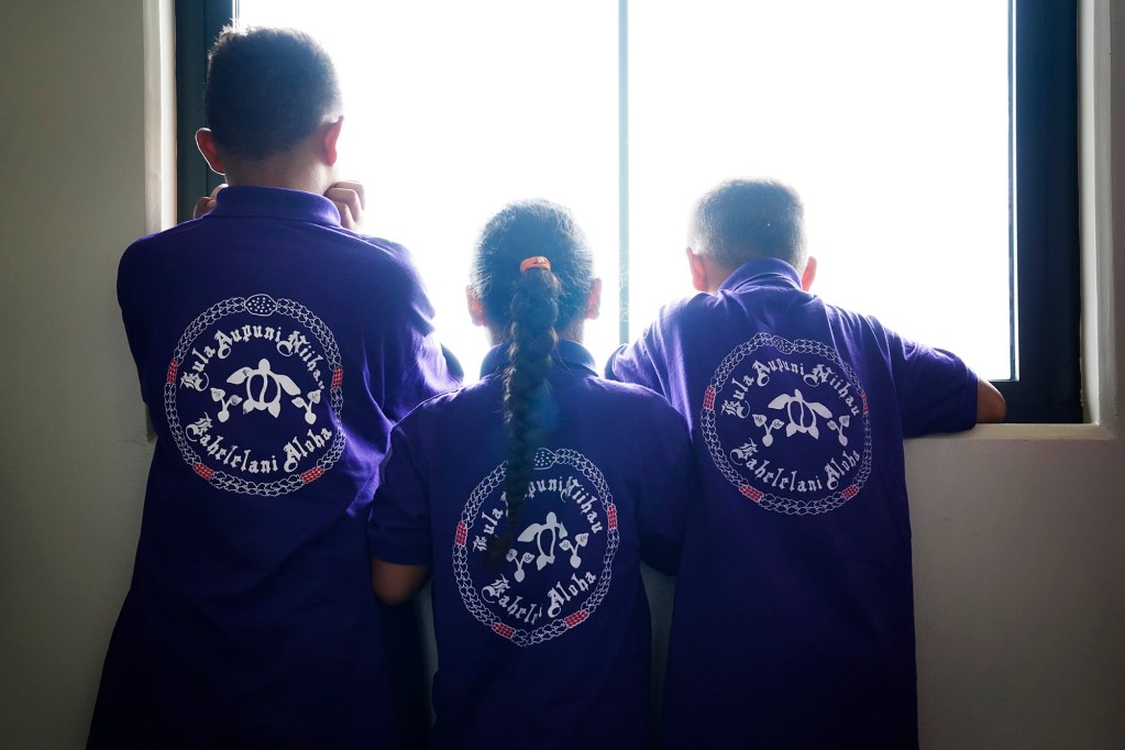Kula Aupuni Niihau A Kahelelani Aloha students look out the window of the Pu‘uhonua Kaulike Building Wednesday, July 22, 2026, in Līhuʻe. One of the few schools dedicated to teaching the Niʻihau dialect of the Hawaiian language is at risk of losing its campus with the school year just a few weeks away. (Kevin Fujii/Civil Beat/2026)