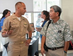 Lt. Cmdr. Matthew Lundin, assistant deputy for contracting for environment and remediation, Navy Closure Task Force-Red Hill (NCTF-RH), speaks with Ernie Lau, manager and chief engineer, Honolulu Board of Water Supply, during the quarterly NCTF-RH open house, held at the Hokulani Community Center in Honolulu, May 21, 2025. NCTF-RH hosted the event for members of the community to learn more about current environmental efforts at the Red Hill Bulk Fuel Storage Facility (RHBFSF) as well as long-term intentions to increase redundancy, resiliency, and security of the Joint Base Pearl Harbor-Hickam drinking water distribution system. Charged with the safe decommissioning of the RHBFSF, NCTF-RH was established by the Department of the Navy as a commitment to the community and the environment. The Navy continues to engage with the people of Hawaii, regulatory agencies, and other stakeholders as NCTF-RH works to safely and deliberately decommission the RHBFSF. (U.S. Navy photo by Mass Communication Specialist 1st Class Glenn Slaughter)