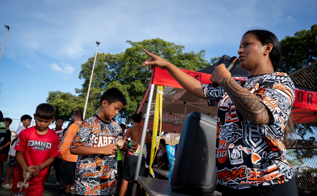 "Aunty" Tasha Santana give direction at a gathering for kendama enthusiasts at ʻEwa Beach Community Park July 13, 2026. (Craig Fujii/Civil Beat/2026)