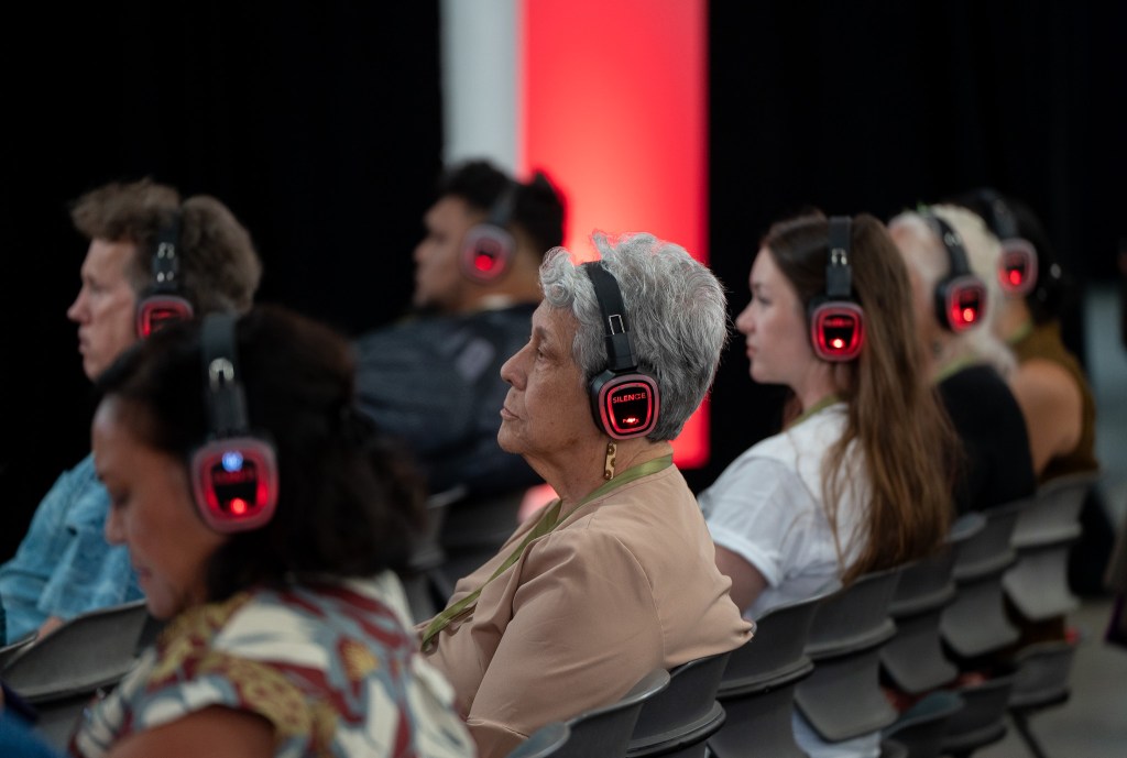 Attendees to the 2026 Native Hawaiʻian Convention wear headphones to listen to a breakout session at Blaisdell Center July 21, 2026. Several sessions started in close proximity and were helped by headphones specific to each session. (Craig Fujii/Civil Beat/2026)