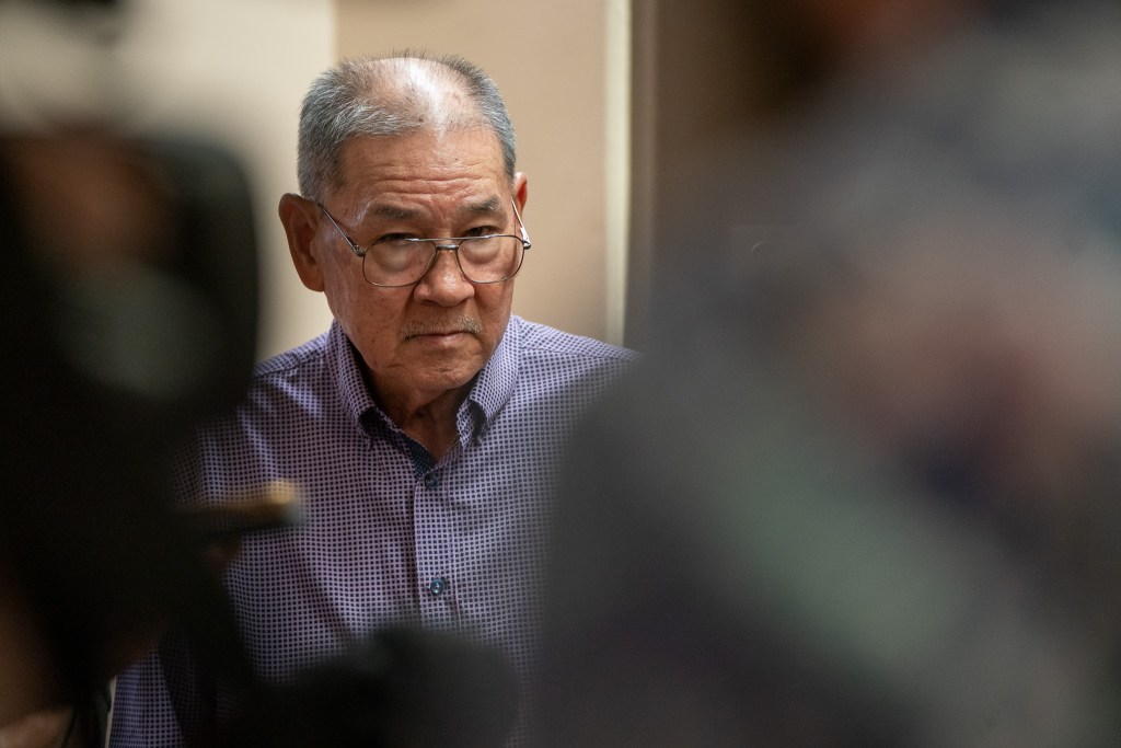 Ford Fuchigami waits for an elevator while his attorney Eric Seitz speaks with the press at Kaʻahumanu Hale July 30, 2026.