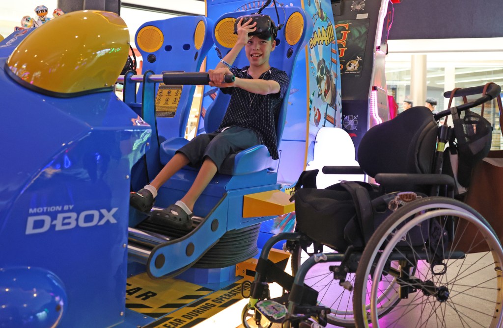 Cylas Eblacas, 12, enjoys a virtual reality ride at Tilt arcade inside Prince Kūhiō Plaza in Hilo. Cylas, who has cerebral palsy, enjoys spending time at the mall because of its spacious walkways and arcade games. Photo by Tim Wright / newsphotoshawaii.com
