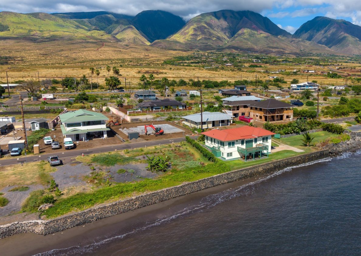 The lots surrounding the so-called "miracle house" on Front Street in Lahaina had been cleared of fire debris and were vacant in July 2024. (Sean M. Hower/Civil Beat/2026)