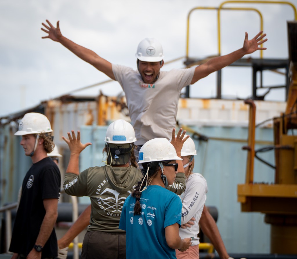 Kawai Hong has a bit of fun with crew mates after arriving home from Papahānaumokuākea August 28, 2026. The Papahānaumokuākea Marine Debris Project, a non-profit, collected 48,000 pounds of debris on a mission interrupted by Hurricane Lala. (Craig Fujii/Civil Beat/2026)