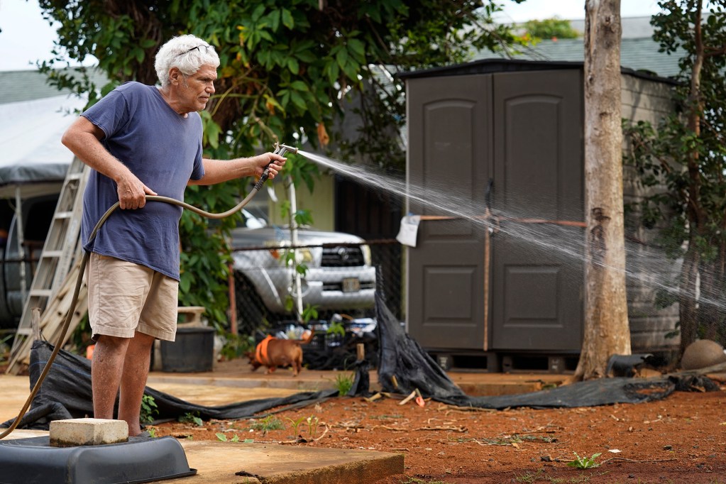 David Kalahiki waters the grass on his property on Wednesday, August. 5, 2026, in Kapaʻa. Kalahiki and Linda Twitchell are legally represented by the Pacific Legal Foundation in a lawsuit against the Department of Hawaiʻian Home Lands and Kali Watson for being evicted based on race and Kalahiki’s 25% Kānaka Maoli "blood quantum”. (Kevin Fujii/Civil Beat/2026)