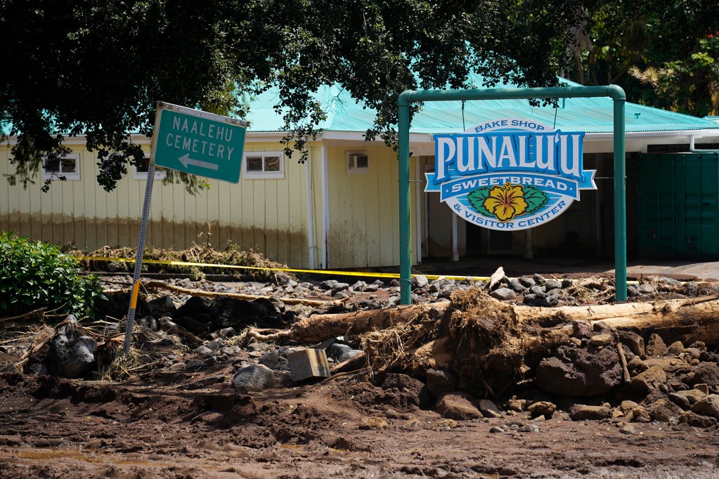 The intersection of Hawaiʻi Belt Road and Kaʻalaiki Road in the town of Nāʻālehu is covered in rubble and debris washed down from mauka Tuesday, Aug. 18, 2026, on Hawaiʻi Island. Hurricane Lala made a close pass to the South Point of the Big Island Saturday. (Kevin Fujii/Civil Beat/2026)