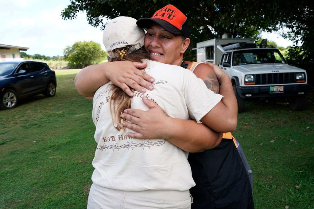 Food truck owner Jolynn Grimes hugs Bible First Mission Church’s Amanda Cruz at the Nāʻālehu Hongwanji Mission community donation hub Tuesday, Aug. 18, 2026, on Hawaiʻi Island. Hurricane Lala made a close pass to the South Point of the Big Island Saturday. (Kevin Fujii/Civil Beat/2026)