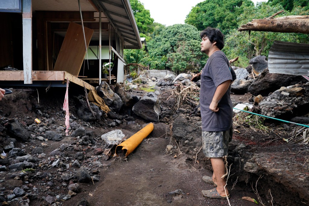 Justin Subica-Kawakami stands near his bedroom on Tuesday, Aug. 18, 2026, in Nāʻālehu. He was sleeping when water and debris from Hurricane Lala swept through the town of Nāʻālehu on Hawaiʻi Island. (Kevin Fujii/Civil Beat/2026)