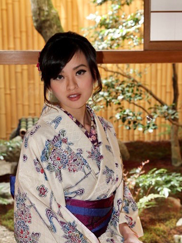 Photo of a young woman dressed in a kimono.