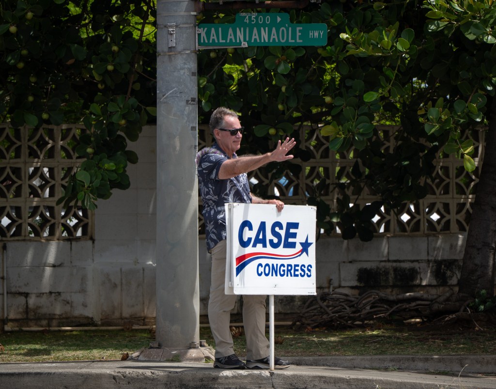 Rep. Ed Case sign waves along Kalanianaʻole Highway August 8, 2026. Case is being challeneged by state Sen. Jarrett Keohokalole. (Craig Fujii/Civil Beat/2026)