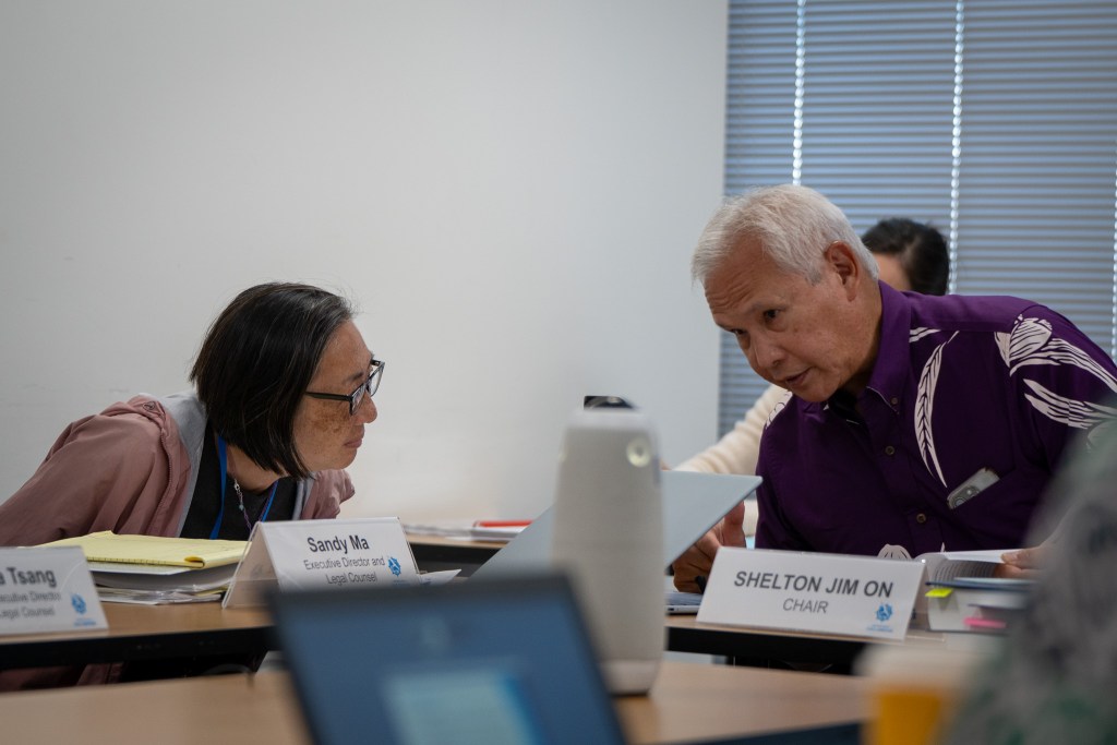 New Executive Director Sandy Ma, left, and Ethics Commision Chair Shelton Jim-On confer at a meeting of the Honolulu Ethics Commision at Kapālama Hale August 19, 2026. (Craig Fujii/Civil Beat/2026)