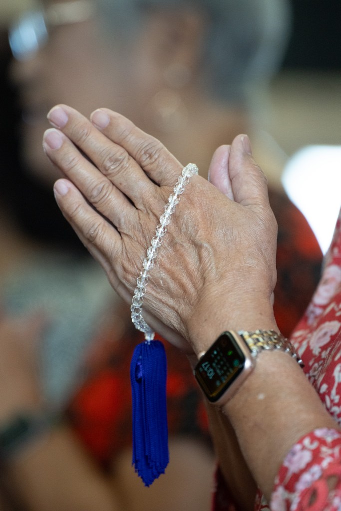 A worshipper in prayerful repose with prayer beads during a service at Honpa Hongwanji in Honolulu August 23, 2026. (Craig Fujii/Civil Beat/2026)