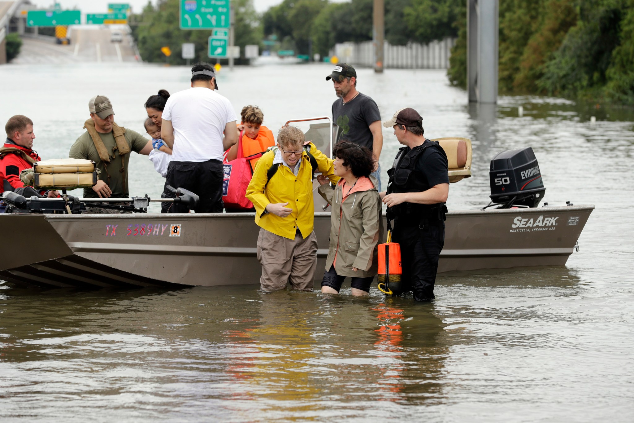 FILE - In this Aug. 27, 2017 file photo, residents are helped from a boat after being rescued from their flooded homes from Tropical Storm Harvey in Houston. Community leaders in the Houston area want to compile a list of rescue volunteers with boats in case another storm like Hurricane Harvey batters Texas. The Houston Chronicle reports the effort by Harris County Judge Ed Emmett and Sheriff Ed Gonzalez would include a database to coordinate volunteer resources. (AP Photo/David J. Phillip, File)
