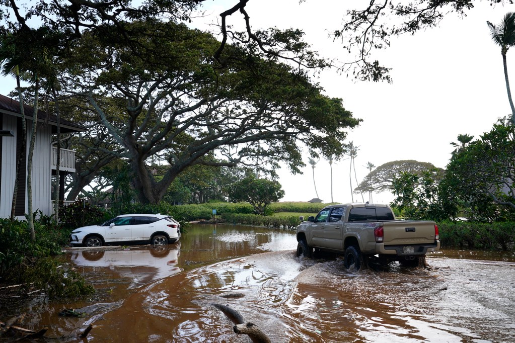 A pick-up truck drives through a flooded parking lot at the Kiahuna Plantation Tuesday, Sept. 8, 2026, in Poʻipū. (Kevin Fujii/Civil Beat/2026)