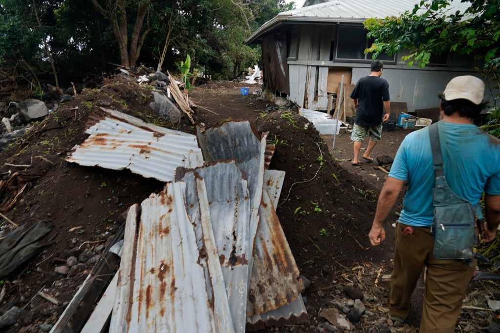 Justin Subica-Kawakami, left, and Kent Kawakami walk toward their house with exposed bedrooms covered with a tarp Thursday, Sept. 24, 2026, in Waiʻōhinu. Hawaiʻi Island is preparing for Tropical Storm, potentially Hurricane Nolo. (Kevin Fujii/Civil Beat/2026)