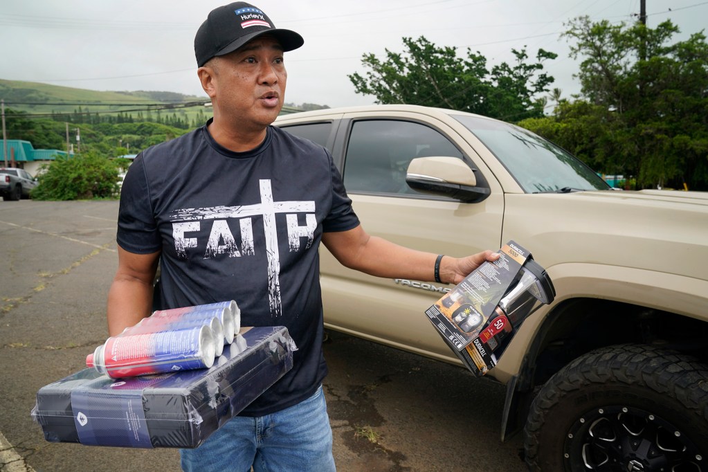 Pastor Troy Gacayan holds a gas stove and solar-powered lantern as Hawaiʻi Island prepares for Tropical Storm Nolo Thursday, Sept. 24, 2026, in Nāʻālehu. (Kevin Fujii/Civil Beat/2026)