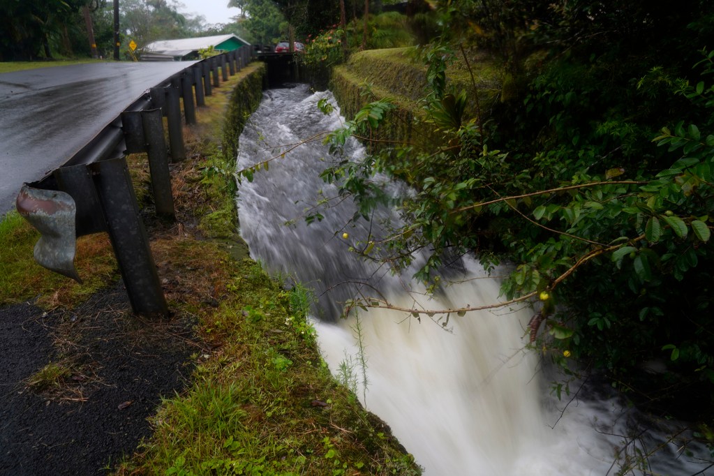 A culvert flows through a Mountain View neighborhood as Hurricane Nolo’s outer bands reach Hawaiʻi Island Saturday, Sept. 26, 2026. (Kevin Fujii/Civil Beat/2026)
