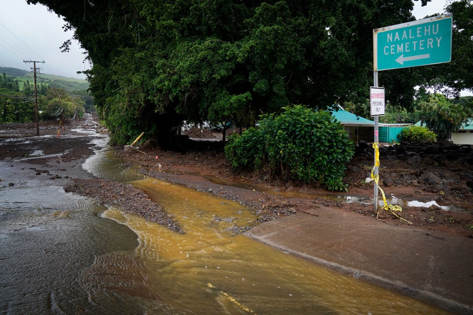 Water snakes its way down Ka‘alaiki Road below the Nāʻālehu Cemetery after Hurricane Nolo Saturday, Sept. 26, 2026, in Nāʻālehu. (Kevin Fujii/Civil Beat/2026)