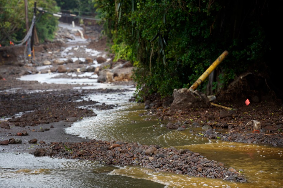 Water snakes its way down Ka‘alaiki Road below the Nāʻālehu Cemetery after Hurricane Nolo Saturday, Sept. 26, 2026, in Nāʻālehu. (Kevin Fujii/Civil Beat/2026)