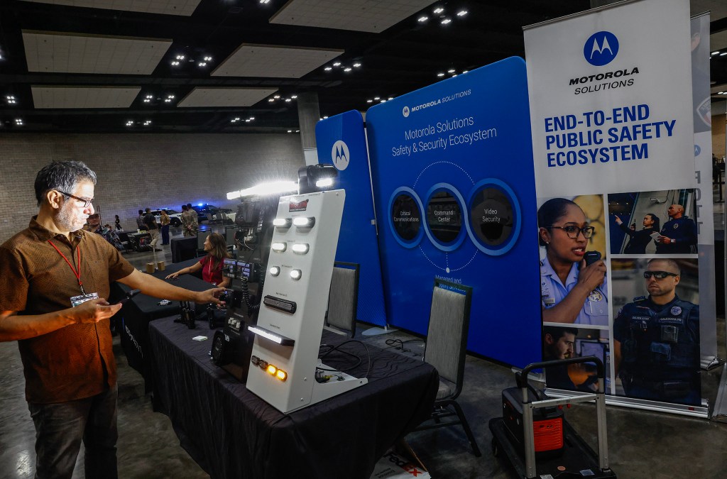 Participants explore the latest tech and equipment, including law enforcement vehicle lighting systems by Motorola, during the Dept. of Law Enforcement’s Public Safety Expo, Saturday, Sept. 26, 2026, at the Hawaiʻi Convention Center in Honolulu. (Jamm Aquino/Civil Beat/2026)
