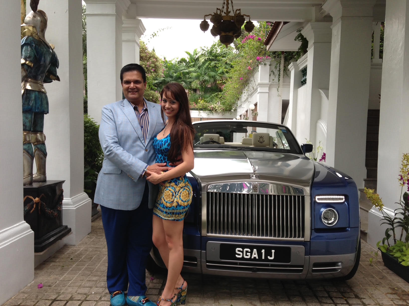 Leonard Francis with Maisa Dourado, a former fiancé, next to a Rolls-Royce at his mansion in Singapore.