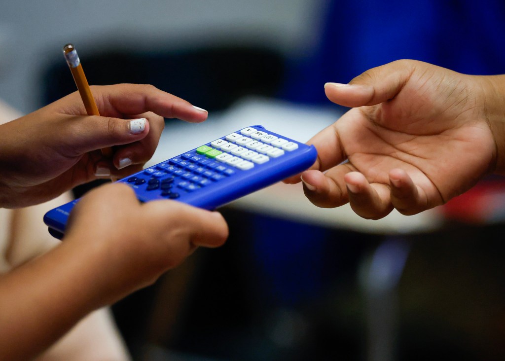 Sixth-graders share a calculator during math class at Kūlia Academy, Wednesday, Sept. 30, 2026, in Kalihi. Kūlia Academy’s middle school math achievement has had unprecedented improvement, and had the highest middle school math scores in the state last year. (Jamm Aquino/Civil Beat/2026)