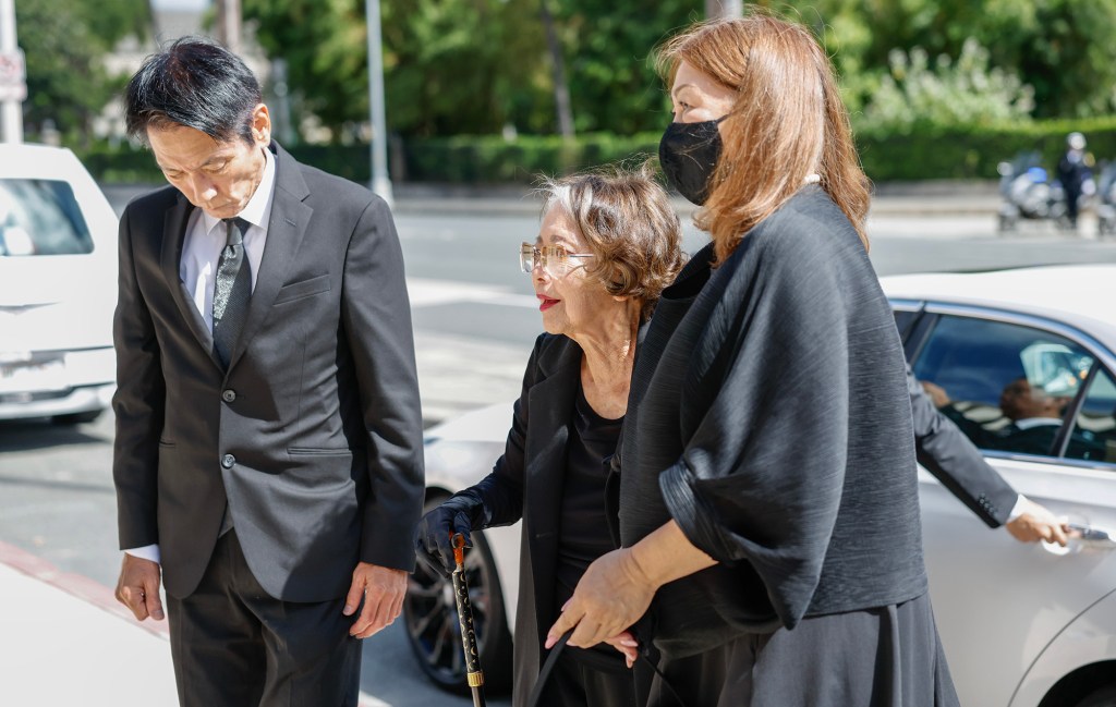 Jean Ariyoshi, middle, widow of former Hawaiʻi Governor George Ariyoshi, is assisted by daughter-in-law Chika Ariyoshi, right, and son Ryozo Ariyoshi, left, during a formal procession for the casket of George Ariyoshi at the State Capitol, Friday, Sept. 18, 2026, in Honolulu. Ariyoshi’s casket will lie in state at the State Capitol rotunda through Saturday.  (Jamm Aquino/Civil Beat/2026)