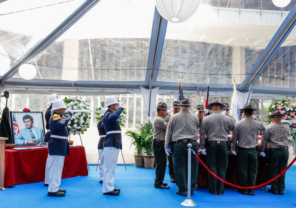 Hawaiʻi State Sheriffs salute after placing the casket of former Hawaiʻi Governor George Ariyoshi at the State Capitol, Friday, Sept. 18, 2026, in Honolulu. Ariyoshi’s casket will lie in state at the State Capitol rotunda through Saturday.  (Jamm Aquino/Civil Beat/2026)