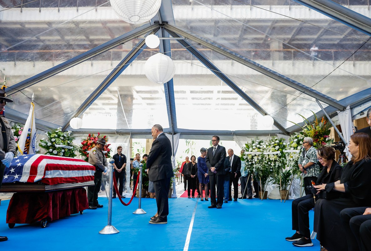 Hawaiʻi Governor Josh Green, left, pauses for a moment of reflection at the casket of former Hawaiʻi Governor George Ariyoshi, Friday, Sept. 18, 2026, in Honolulu. Ariyoshi’s casket will lie in state at the State Capitol rotunda through Saturday.  (Jamm Aquino/Civil Beat/2026)