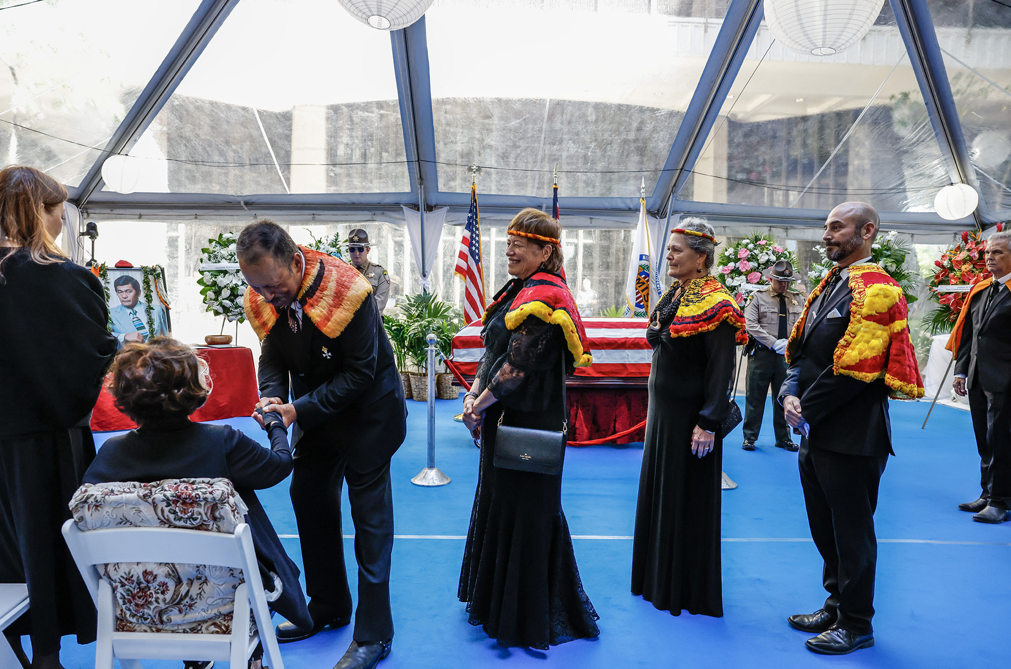 Members of the Royal Order of Kamehameha I arrive to pay respects to Jean Ariyoshi, second from left, and the Ariyoshi family during a formal procession for the casket of former Hawaiʻi Governor George Ariyoshi, Friday, Sept. 18, 2026, in Honolulu. Ariyoshi’s casket will lie in state at the State Capitol rotunda through Saturday.  (Jamm Aquino/Civil Beat/2026)