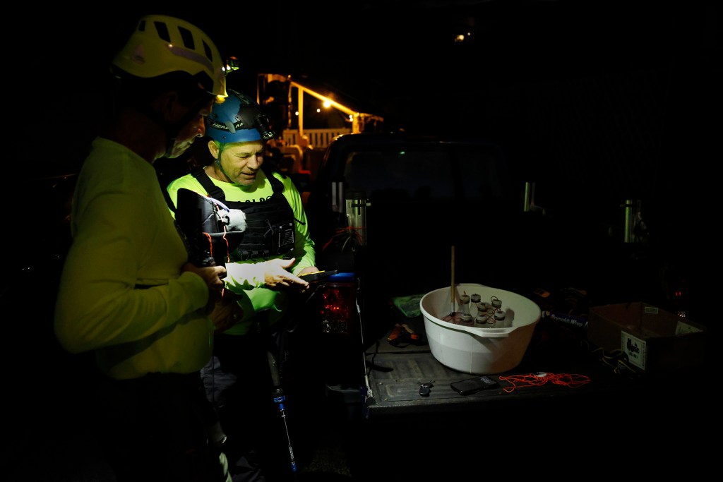 Michael Shiroma, from left, and Michael Healy, test radios before hunting invasive coqui frogs Monday, Oct. 5, 2026, in Honolulu. (Kevin Fujii/Civil Beat/2026)