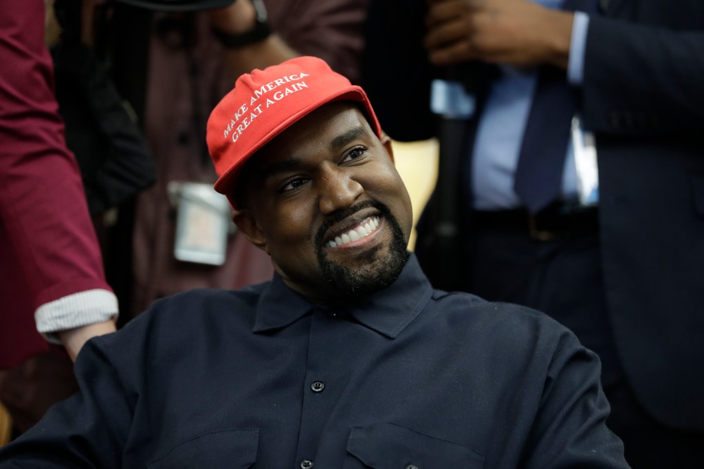 FILE - Rapper Kanye West wears a Make America Great again hat during a meeting with President Donald Trump in the Oval Office of the White House in Washington on Oct. 11, 2018. West says he is no longer a Trump supporter. The rapper, who once praised Trump, tells Forbes in a story published Wednesday that he is “taking the red hat off” — a reference to Trump’s trademark red “Make America Great Again” cap. West also insisted that his weekend announcement that he’s running for President was not a stunt to drum up interest in an upcoming album.  (AP Photo/Evan Vucci, File)