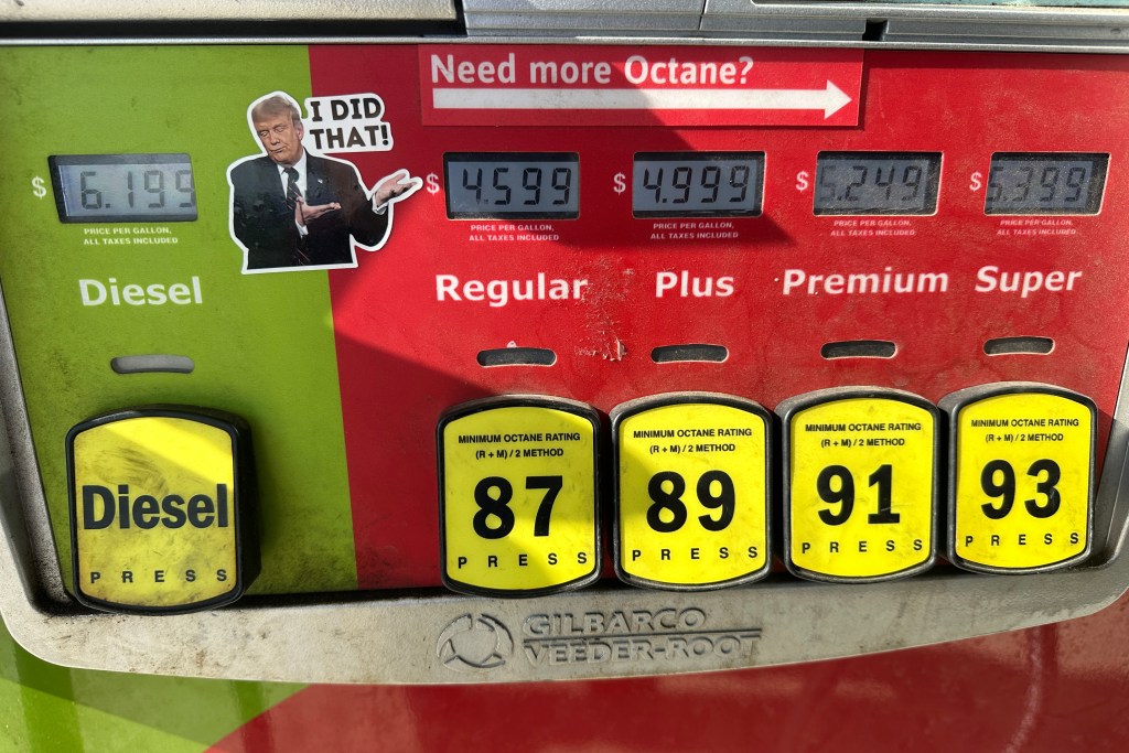 A sticker placed by an unidentified person depicting President Donald Trump and reading "I DID THAT!" is affixed beside gasoline and diesel prices at a gas station in Newtown, Pa., Wednesday, Sept. 9, 2026, as rising pump prices test Trump's campaign pledge to cut energy costs in half. (AP Photo/Ted Shaffrey)