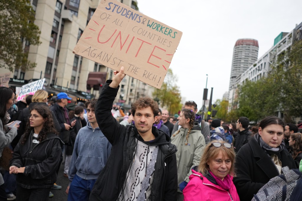 Protesters take part in a demonstration against rising living costs in Paris, Saturday, Oct. 24, 2026. (AP Photo/Thibault Camus)