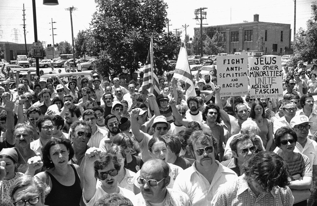 A large group of anti-Nazi demonstrators chant at a park in the predominantly Jewish Chicago suburb of Skokie, Illinois, July 4, 1977, protesting a possible future march in Skokie by Nazis. Three separate demonstrations against the Nazis were held in the Chicago area on Monday. The small Chicago Nazi party had planned earlier to march in Skokie on July 4, but changed plans pending a court appeal. (AP Photo/Charles Knoblock)