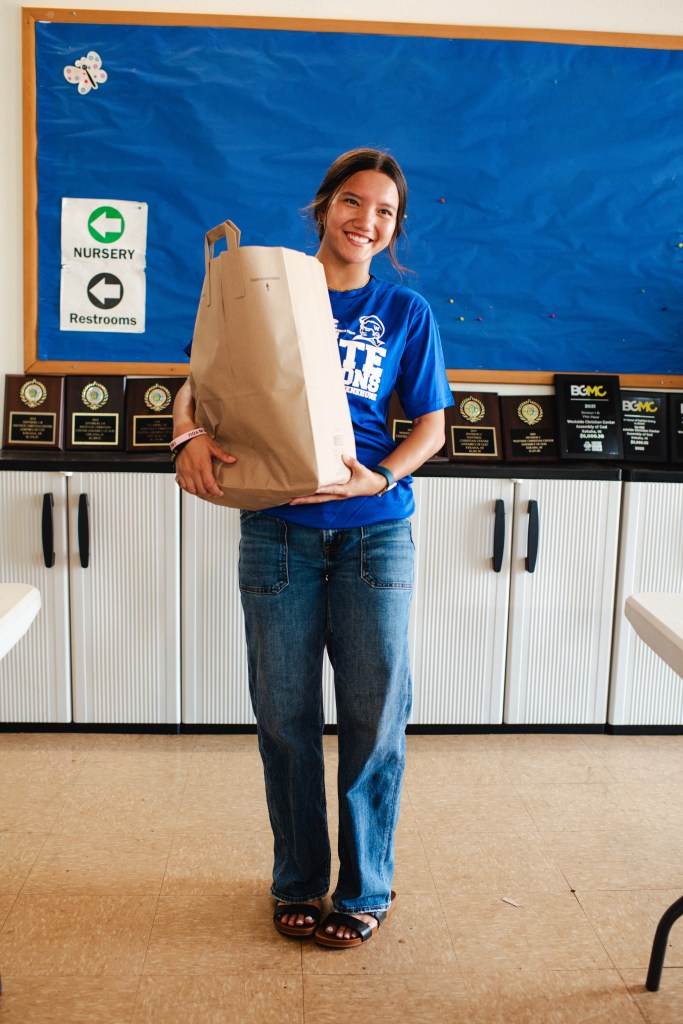 Kekaha, Hi - September 30, 2026: 16 year old Kloie Linoz is one of the 40 teenagers, adults and kūpuna, or elders, that helped with the food distribution at the Westside Christian Center. They expected to pass out 300 bags over the next two hours, more than double the amount the church and area nonprofit E Ola Mau normally do at their monthly food giveaways. Akasha Rabut for The Guardian