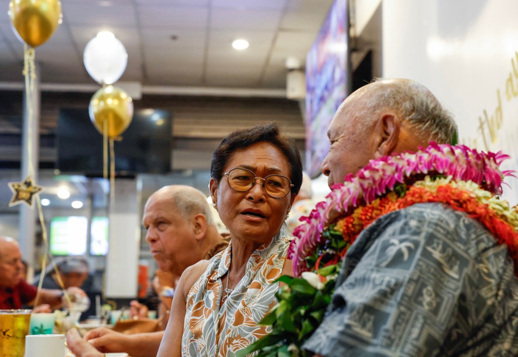 Francis Lum, right, sings a duet with girlfriend Leona Pereza, middle, during his 90th birthday party celebration, Saturday, Oct. 3, 2026, in Kāneʻohe.. (Jamm Aquino/Civil Beat/2026)