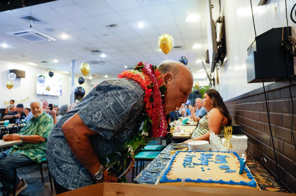 Francis Lum blows out candles on his birthday cake during his 90th birthday party celebration, Saturday, Oct. 3, 2026, in Kāneʻohe.. (Jamm Aquino/Civil Beat/2026)