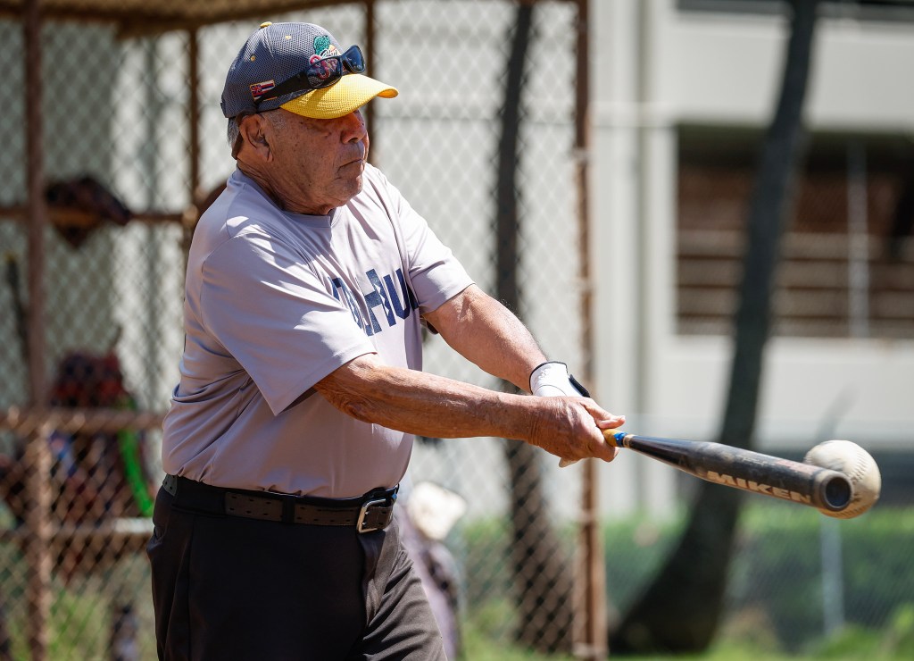 Francis Lum hits a double during a softball game, Monday, Oct. 5, 2026, in Mōʻiliʻili. Lum plays three times a week along with batting practice on Tuesdays.  (Jamm Aquino/Civil Beat/2026)