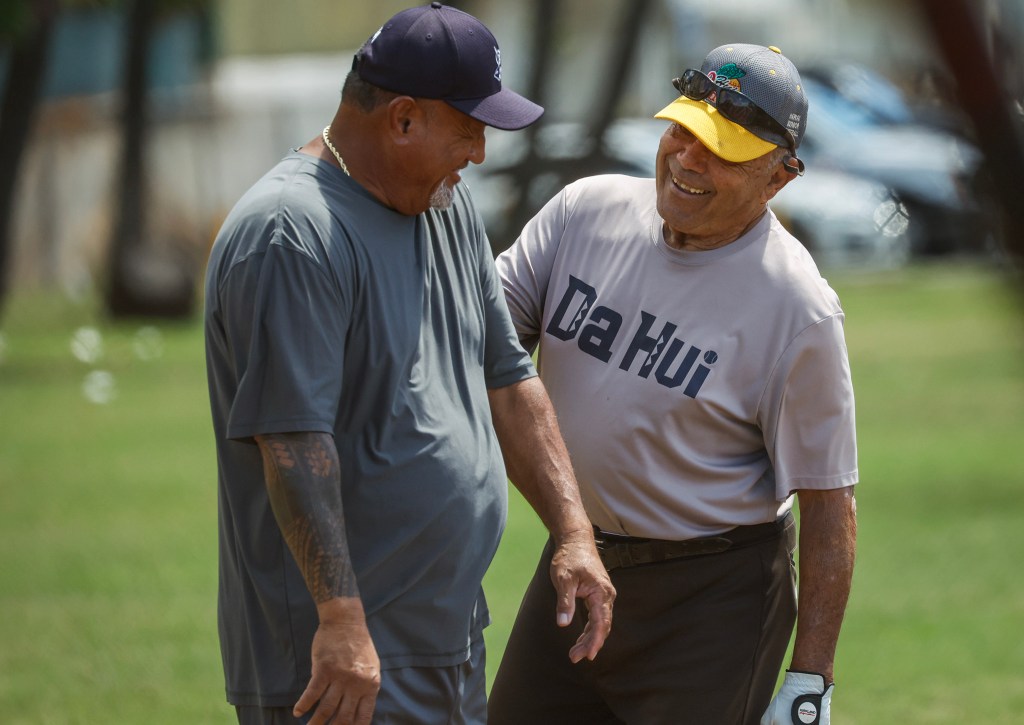 Francis Lum, right, shares a laugh with team mate Fetu Sue during a softball game, Monday, Oct. 5, 2026, in Mōʻiliʻili. Lum plays three times a week along with batting practice on Tuesdays.  (Jamm Aquino/Civil Beat/2026)