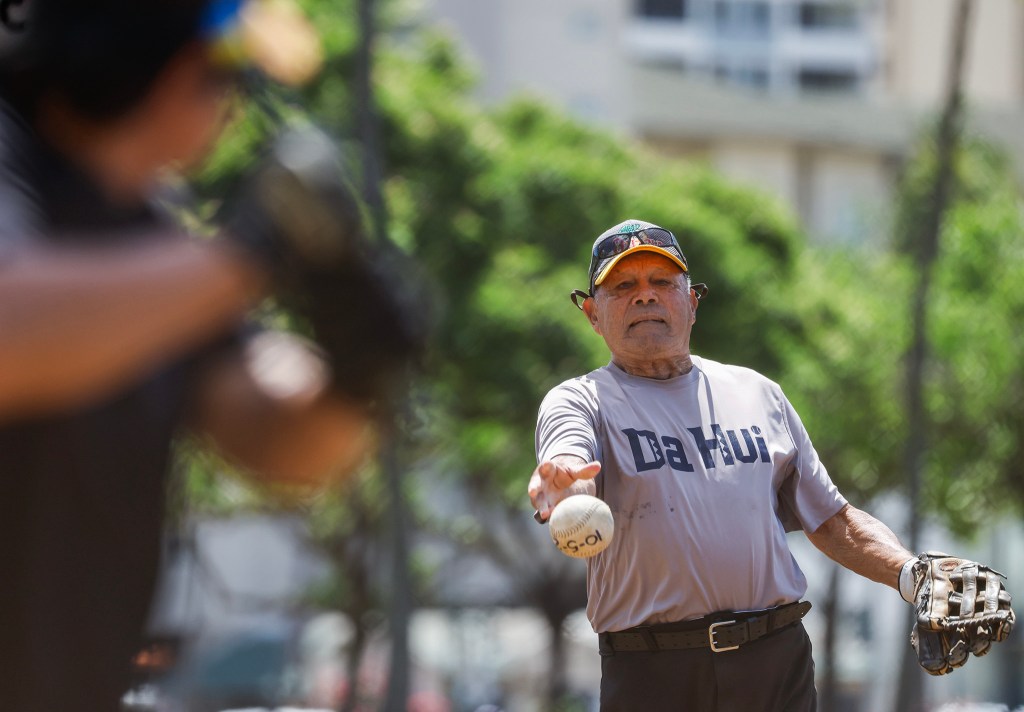 Francis Lum pitches during a softball game, Monday, Oct. 5, 2026, in Mōʻiliʻili. Lum plays three times a week along with batting practice on Tuesdays.  (Jamm Aquino/Civil Beat/2026)