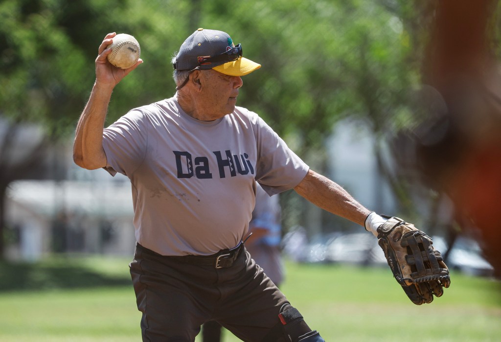Francis Lum throws the ball to first base during a softball game, Monday, Oct. 5, 2026, in Mōʻiliʻili. Lum plays three times a week along with batting practice on Tuesdays.  (Jamm Aquino/Civil Beat/2026)