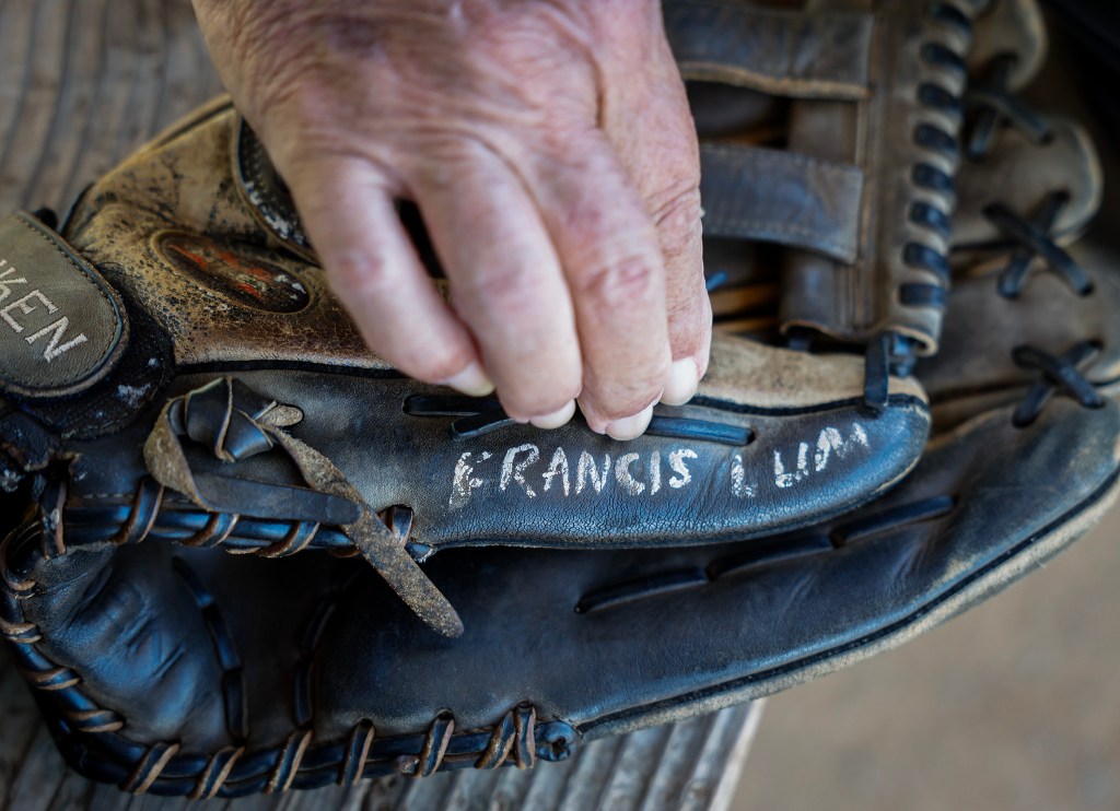 Francis Lum grabs his mitt prior to taking to the field in a softball game, Monday, Oct. 5, 2026, in Mōʻiliʻili. Lum plays three times a week along with batting practice on Tuesdays.  (Jamm Aquino/Civil Beat/2026)