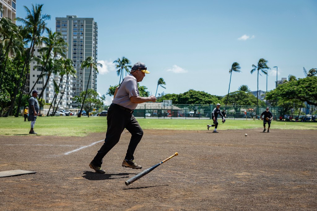 Francis Lum runs to first base after connecting for a hit during a softball game, Monday, Oct. 5, 2026, in Mōʻiliʻili. Lum plays three times a week along with batting practice on Tuesdays.  (Jamm Aquino/Civil Beat/2026)
